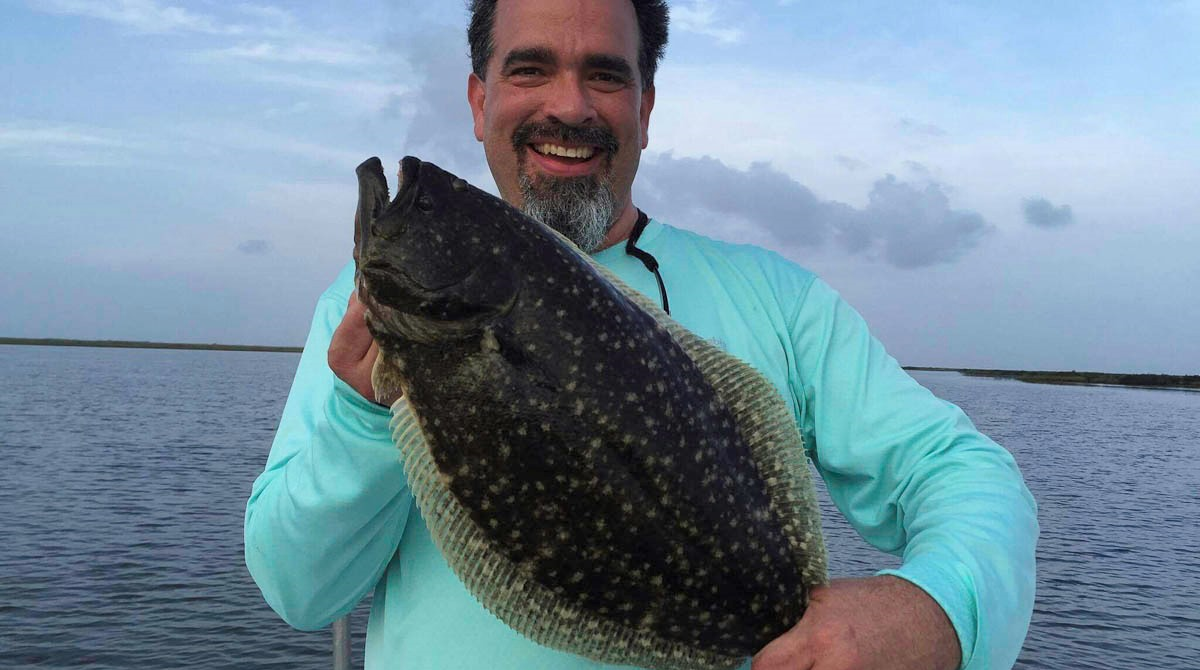 Omar showing off a big ole "Saddle Blanket" Flounder