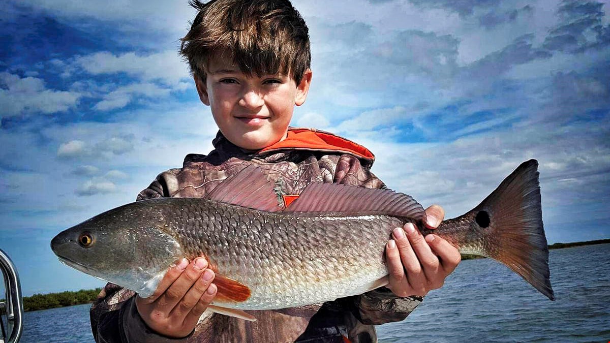 Miles Carson showing off a solid Redfish